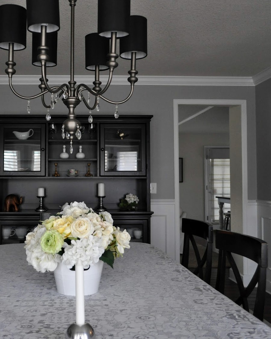 Detail of a crystal chandelier over a dining room hutch